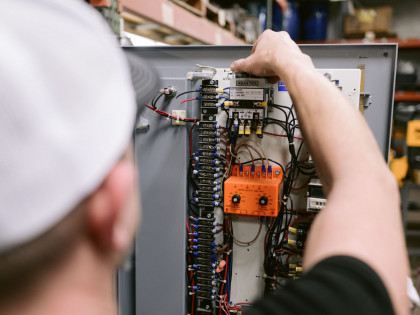 Electrician Working On Breaker Panel